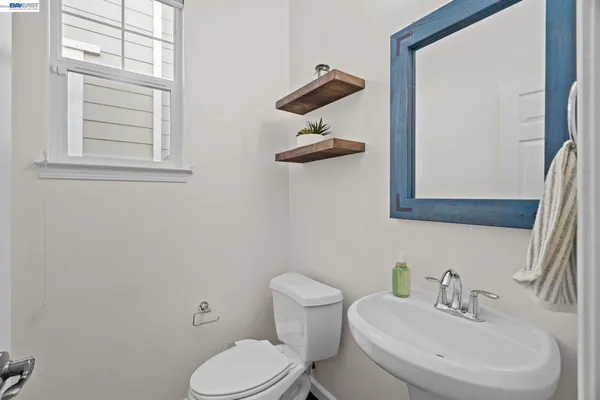 a bathroom with a toilet a sink and mirror