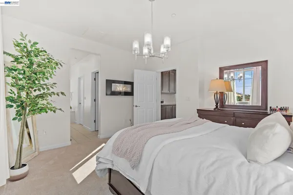 a bedroom with a bed and a chandelier