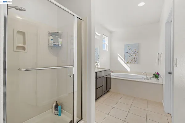 a bathroom with a tub sink and mirror