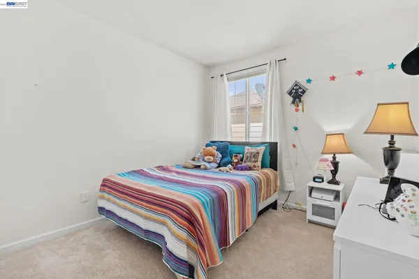 a bed room with a bed and a lamp