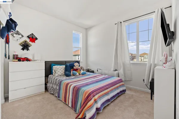 a bedroom that has a bed and a closet