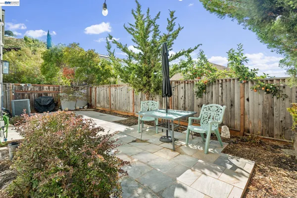 a view of a house with backyard and sitting area
