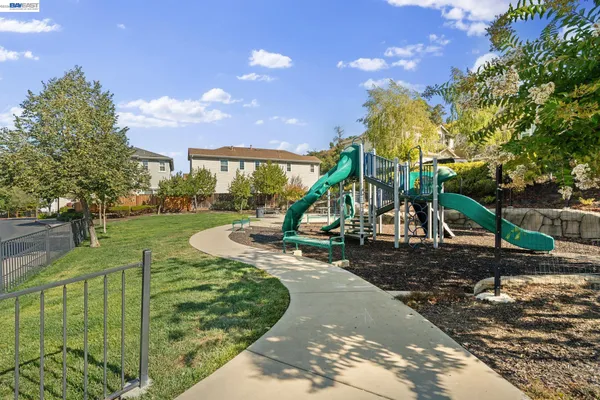 a view of a house with a big yard and sitting area