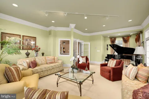 a living room with stainless steel appliances kitchen island furniture and a flat screen tv