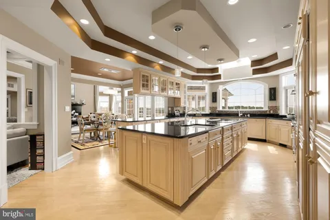 a dining room with furniture a fireplace and large window