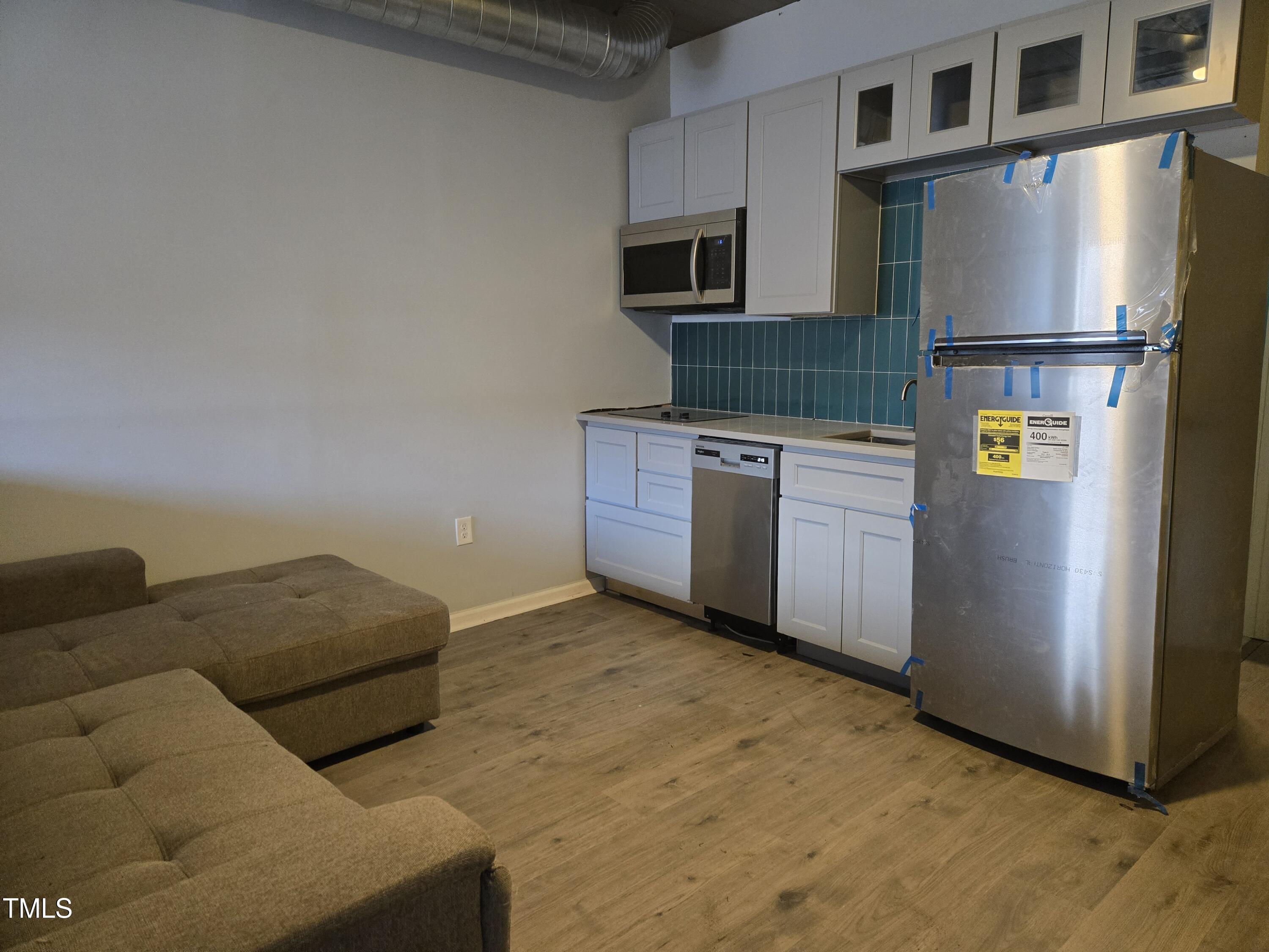 116 East Main Street Durham, NC 27701 - Photo 12 of 15 a kitchen with stainless steel appliances granite countertop a refrigerator a stove and a microwave