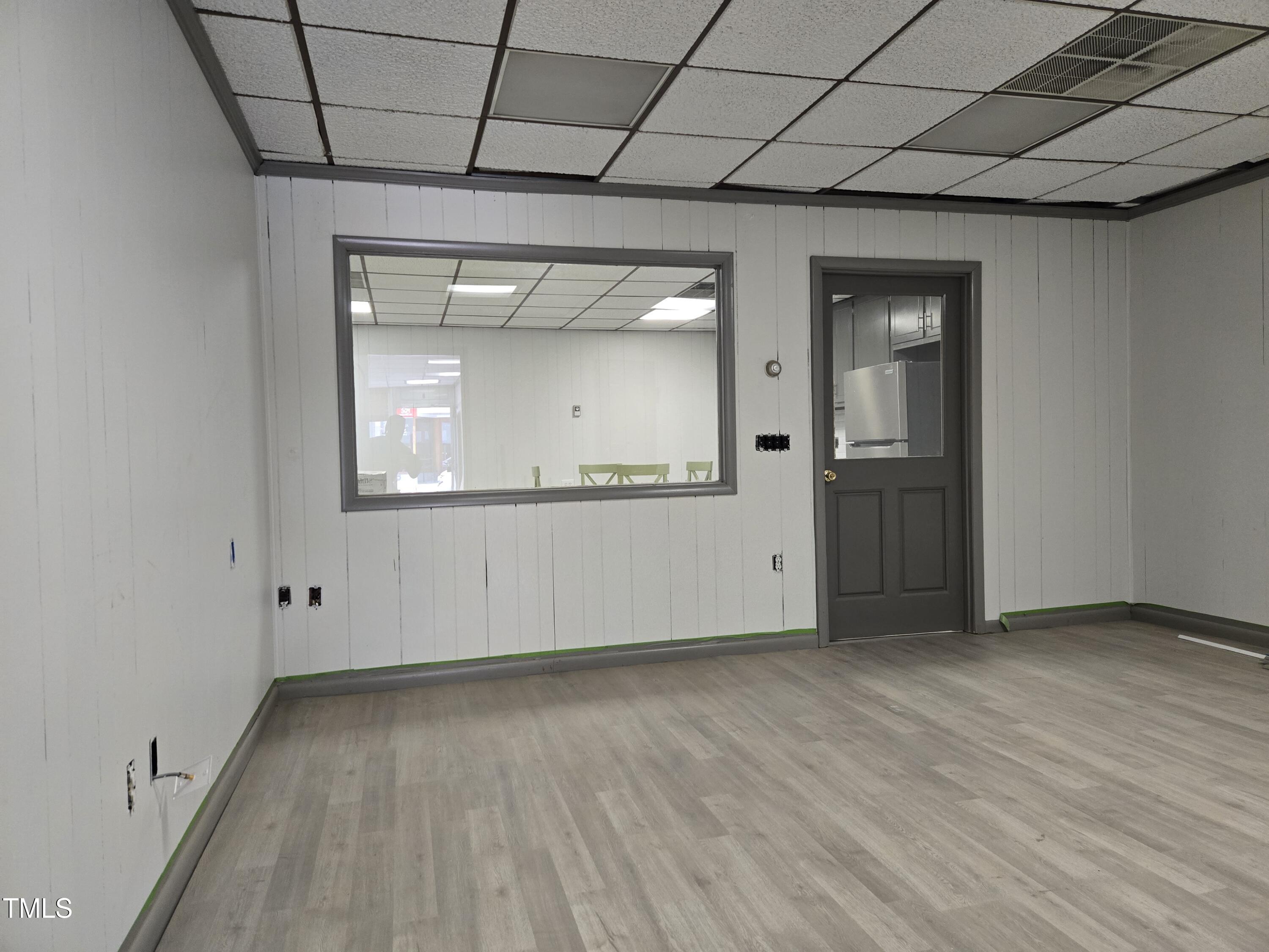116 East Main Street Durham, NC 27701 - Photo 5 of 15 an empty room with wooden floor and windows