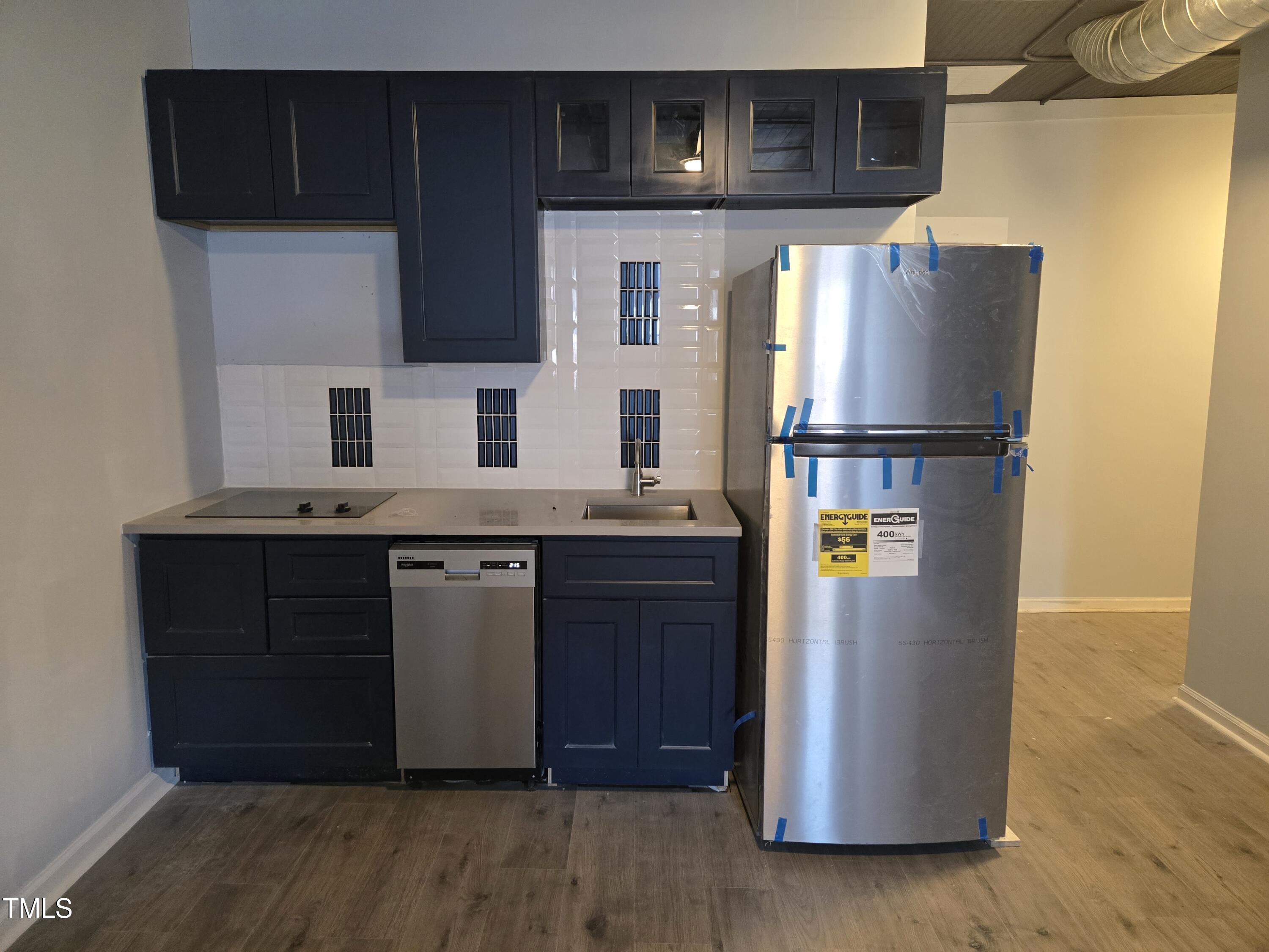 116 East Main Street Durham, NC 27701 - Photo 10 of 15 a kitchen with stainless steel appliances granite countertop a refrigerator a stove and a microwave