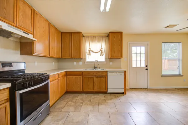 a view of a kitchen with a sink and a window