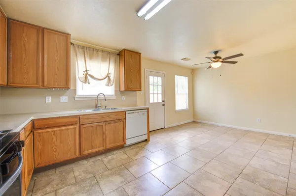 a kitchen with stainless steel appliances granite countertop a stove sink and cabinets