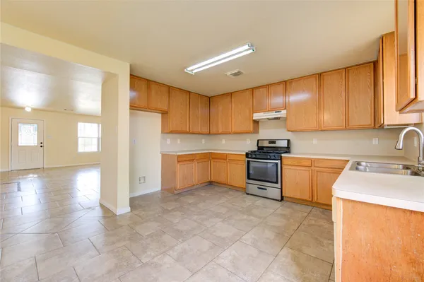 a kitchen with a stove a sink and a refrigerator