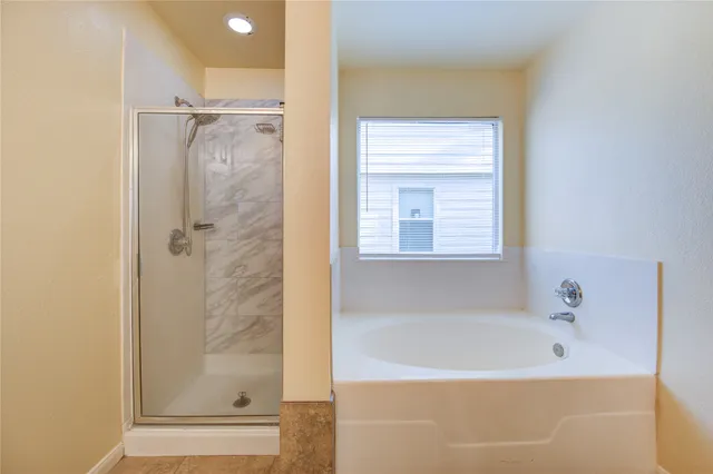 a bathroom with a bathtub and shower