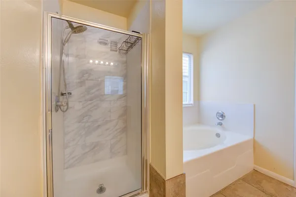 a bathroom with a granite countertop sink mirror vanity and toilet