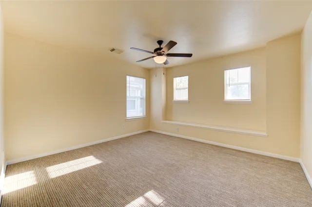 en empty room with closet and windows