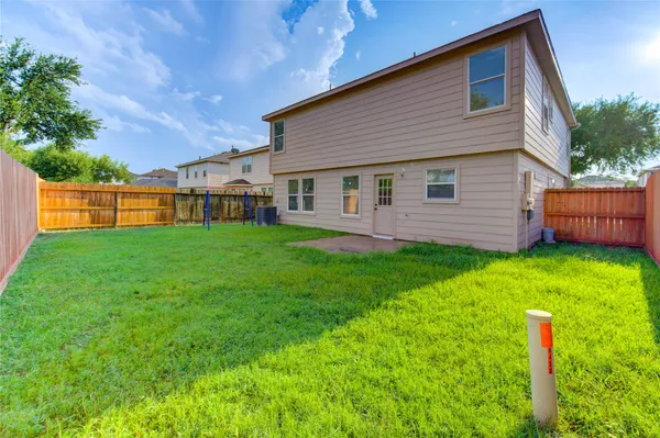 a backyard of a house with childrens swings and slides