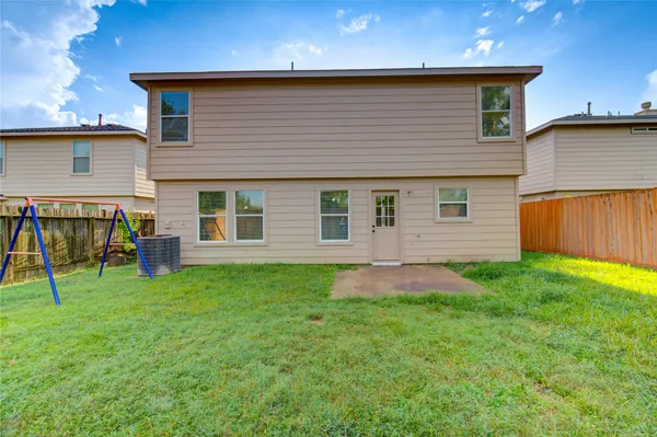 a backyard of a house with table and chairs