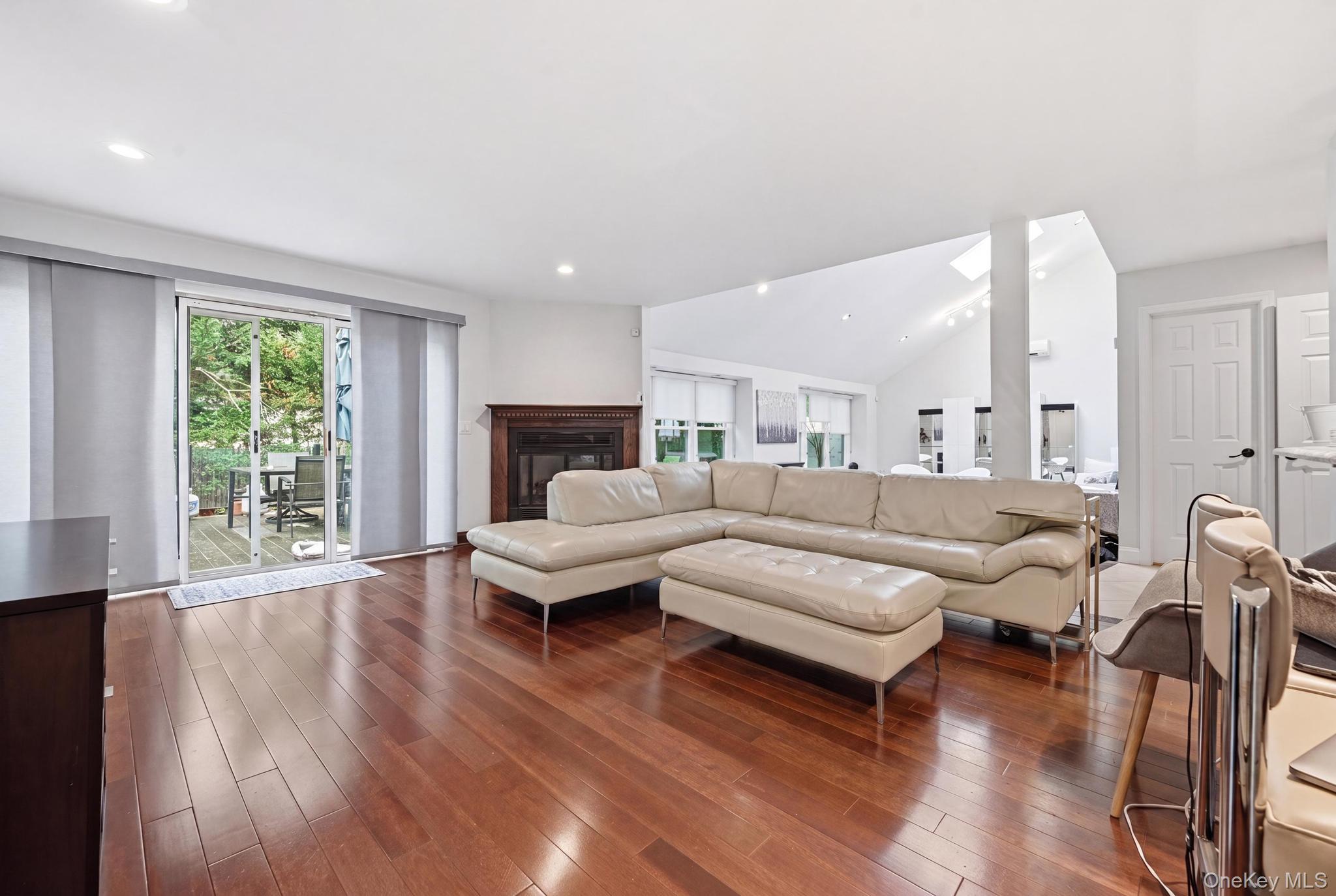 19 Sunset Road West Albertson, NY 11507 - Photo 6 of 24 Hardwood flooring throughout a living space featuring a fireplace with a wood mantle