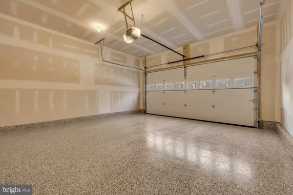 a view of a kitchen with wooden floor and windows