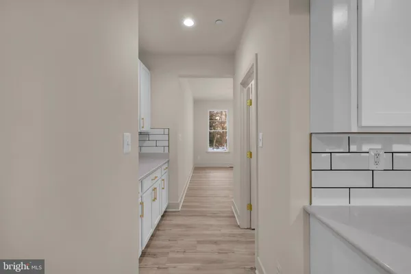 a balcony with chairs and a potted plant