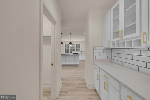 a view of a kitchen with a sink and dishwasher stove top oven with wooden floor