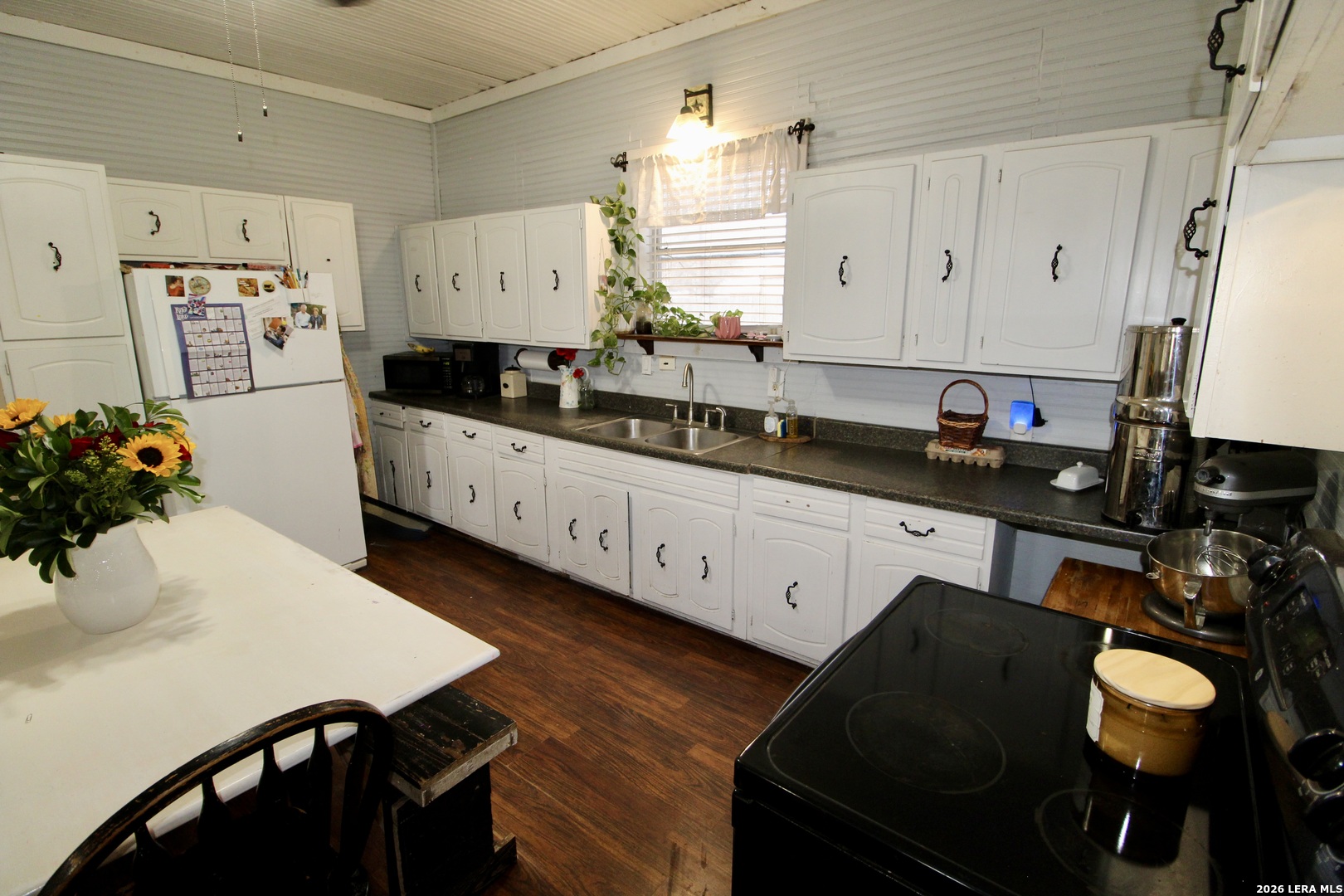 19231 Benton Lytle, TX 78052 - Photo 15 of 34 a kitchen with a table chairs stove and cabinets