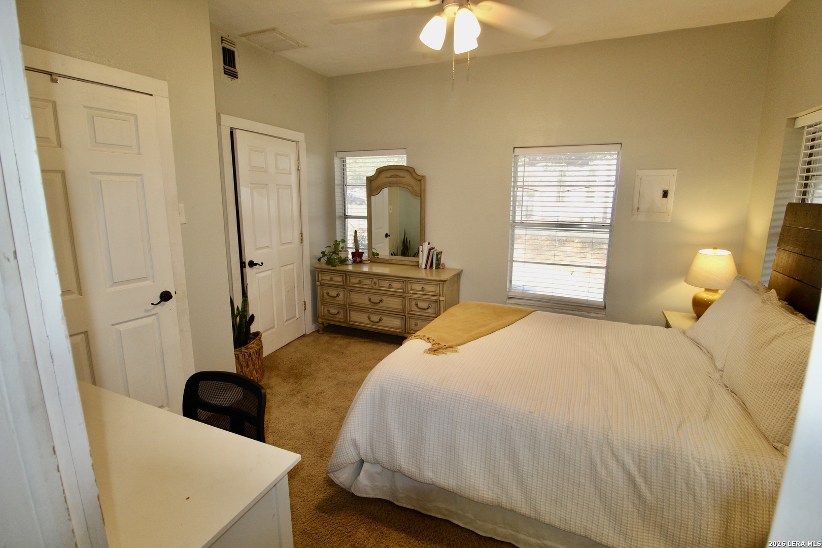 19231 Benton Lytle, TX 78052 - Photo 17 of 34 a bedroom with a bed and a chandelier