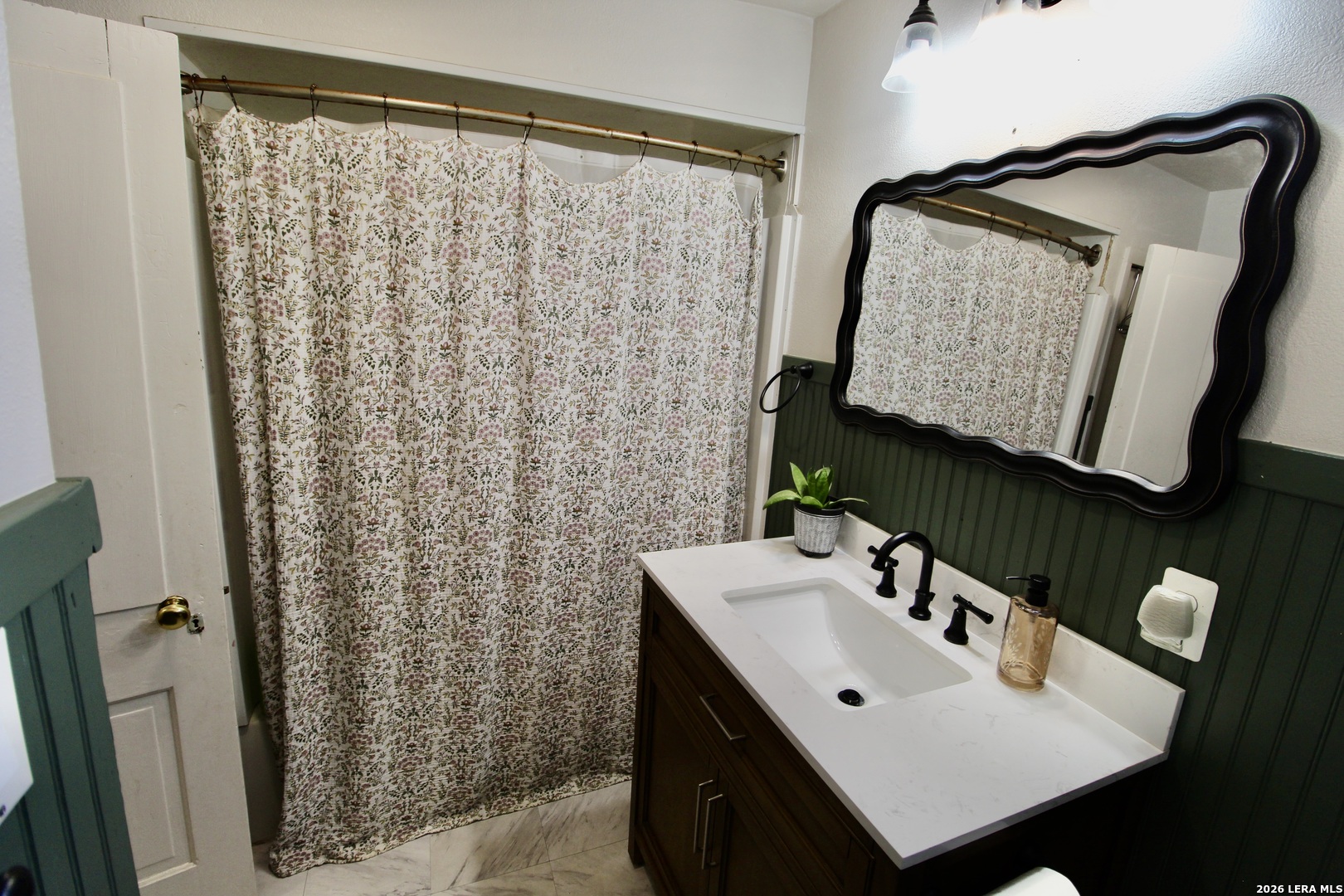 19231 Benton Lytle, TX 78052 - Photo 22 of 34 a bathroom with a sink vanity and a mirror