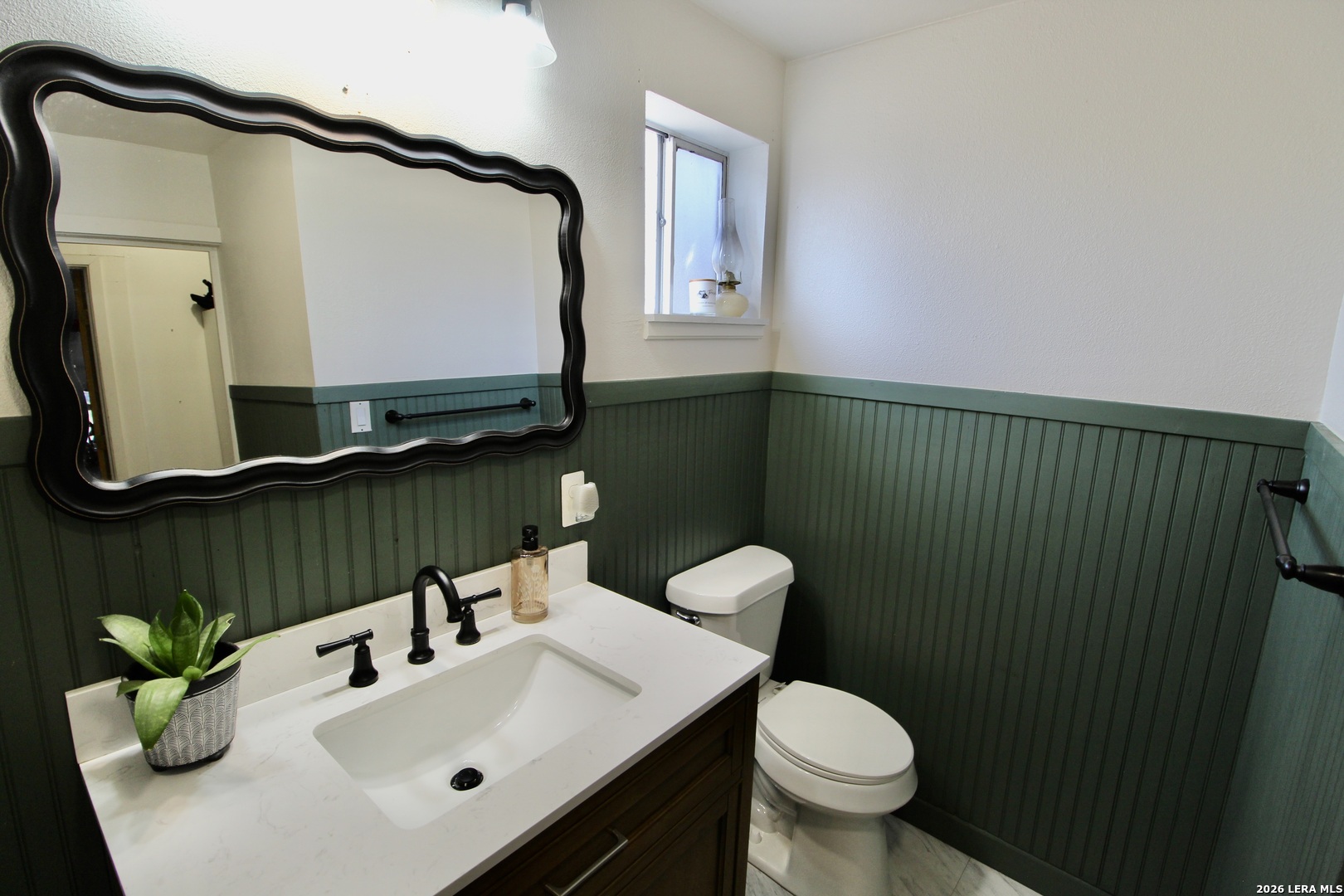 19231 Benton Lytle, TX 78052 - Photo 23 of 34 a bathroom with a sink toilet and mirror