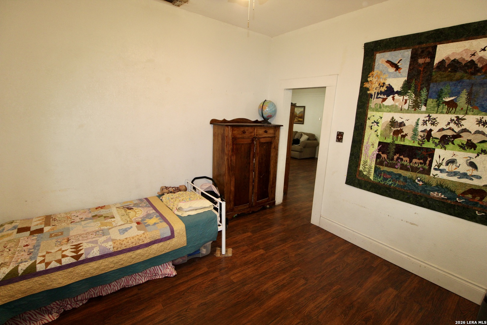19231 Benton Lytle, TX 78052 - Photo 27 of 34 a bedroom with bed and wooden floor
