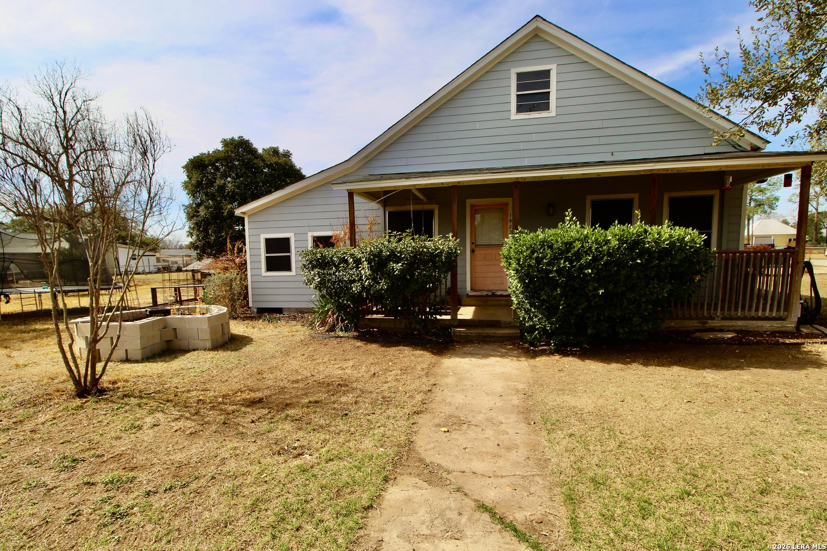 19231 Benton Lytle, TX 78052 - Photo 3 of 34 a front view of house with yard and trees in the background
