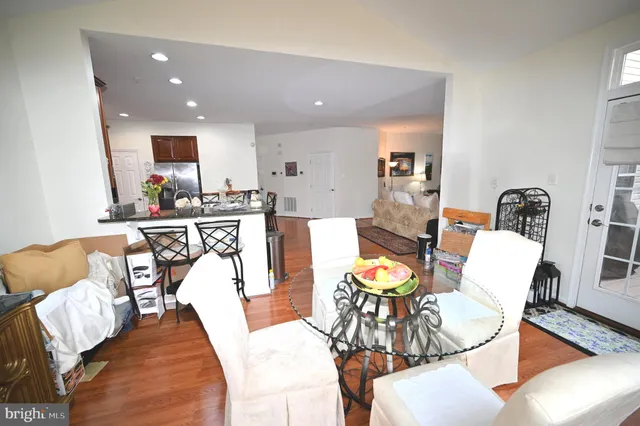 a living room with furniture kitchen view and a large window
