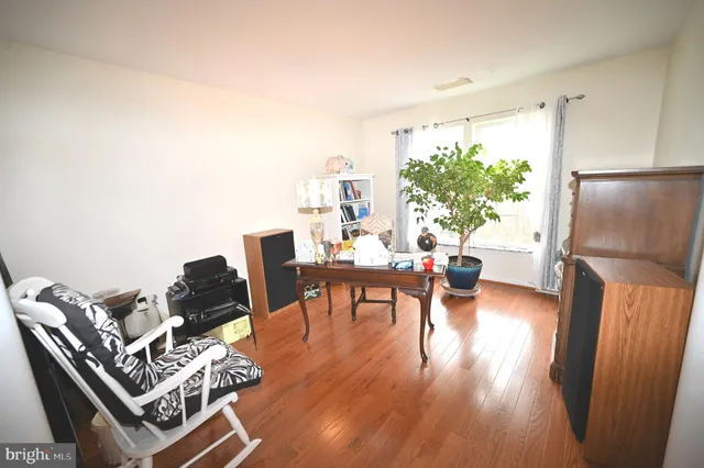 a view of a hallway view with wooden floor and staircase