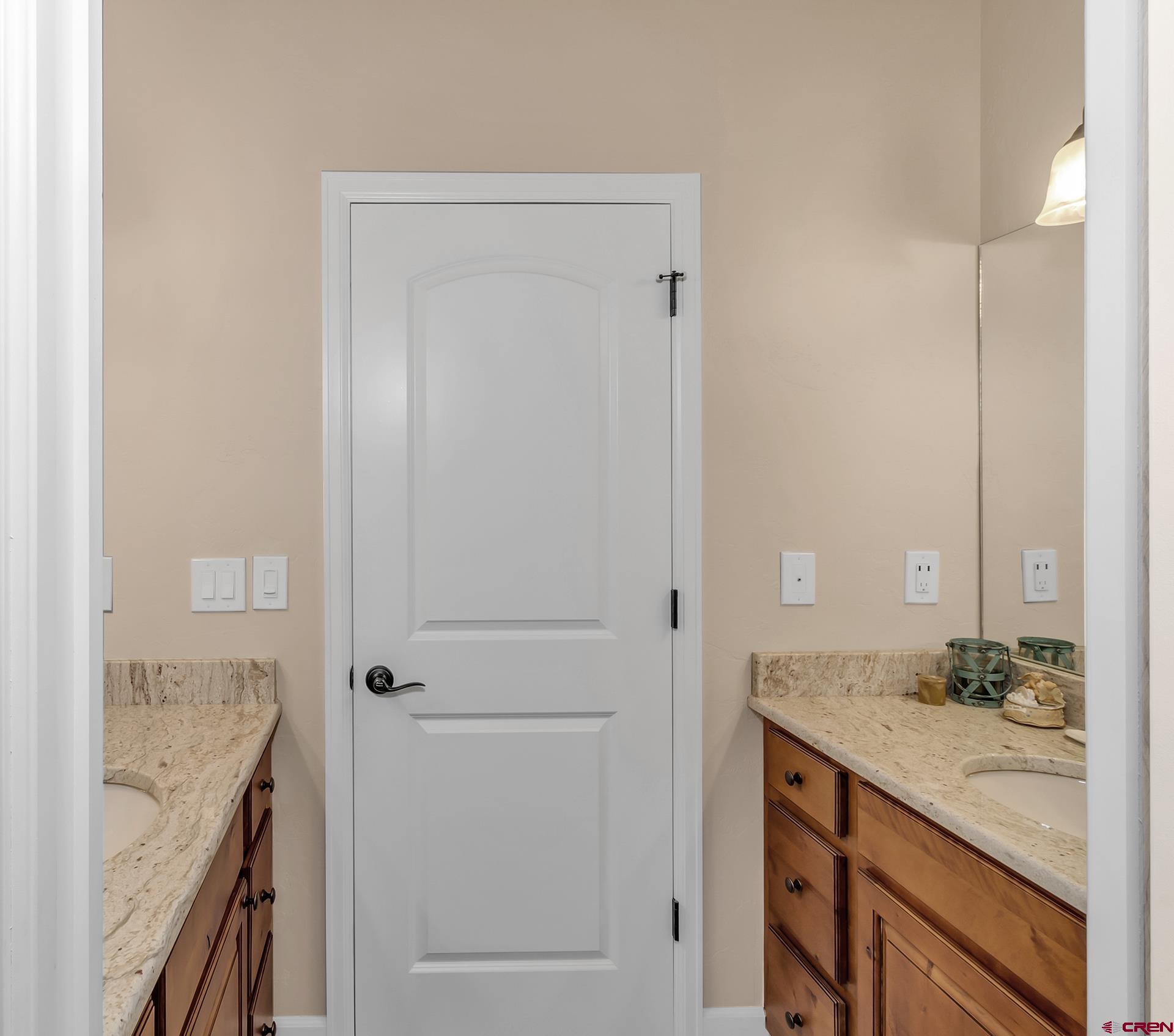 8460 1950th Road Austin, CO 81410 - Photo 18 of 35 a bathroom with a granite countertop sink and a mirror