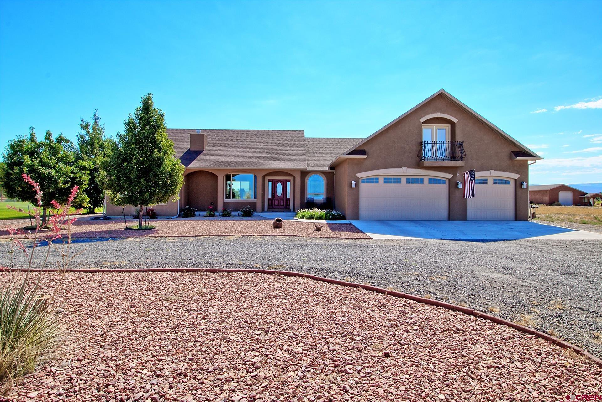 8460 1950th Road Austin, CO 81410 - Photo 2 of 35 a front view of a house with a yard