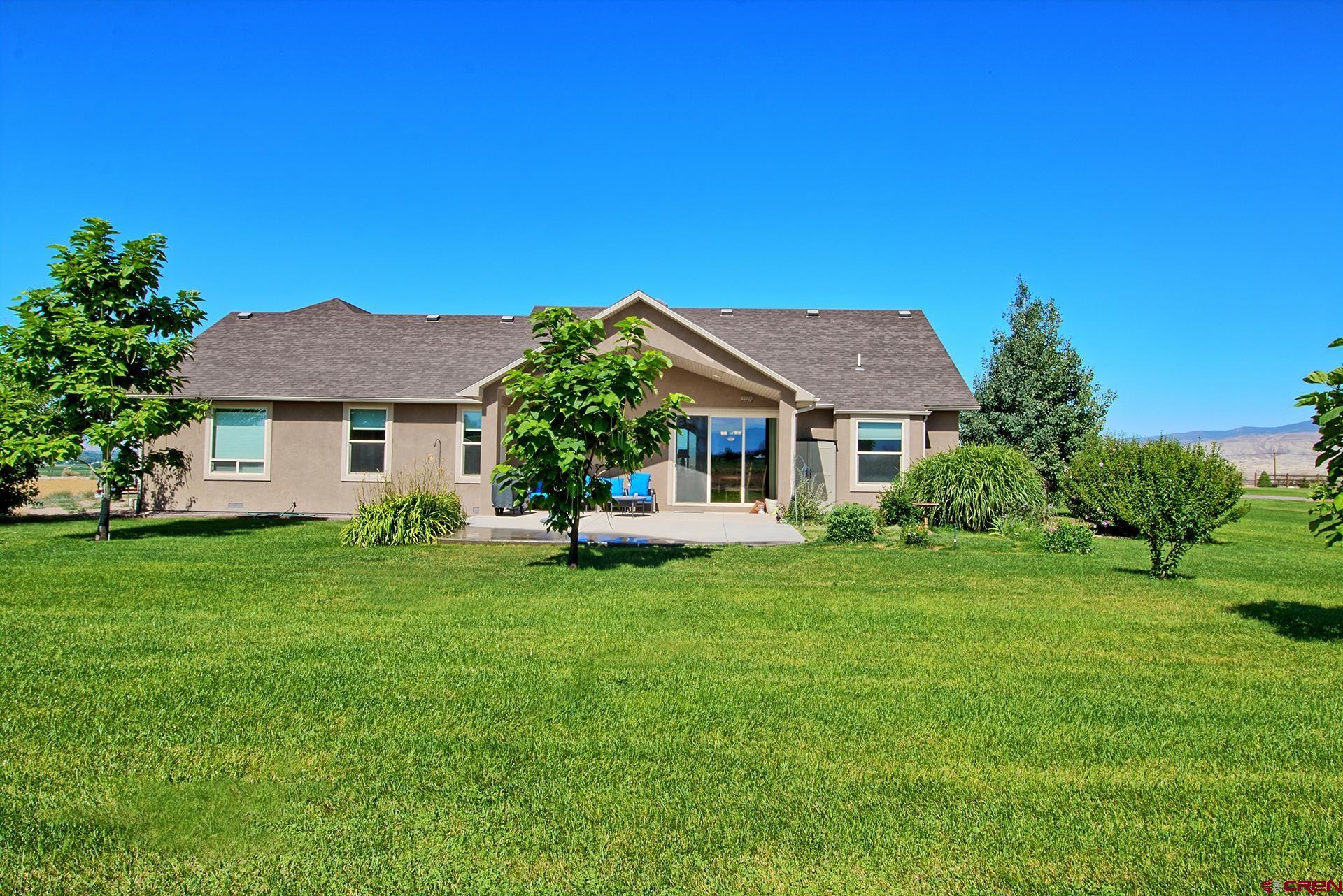 8460 1950th Road Austin, CO 81410 - Photo 23 of 35 a front view of a house with a garden