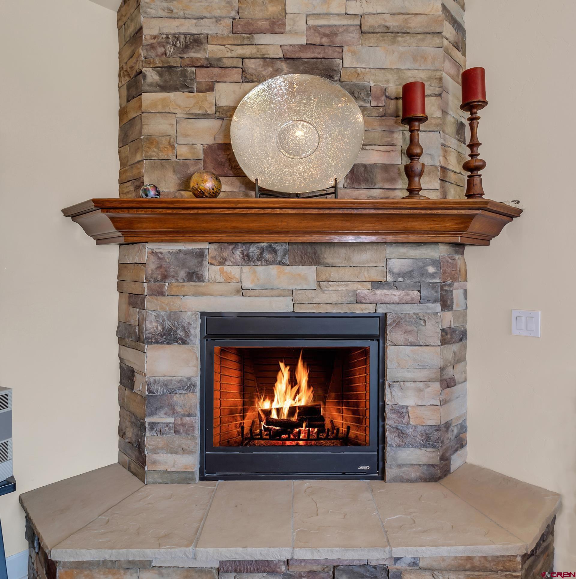 8460 1950th Road Austin, CO 81410 - Photo 4 of 35 a fireplace with a clock on top of it