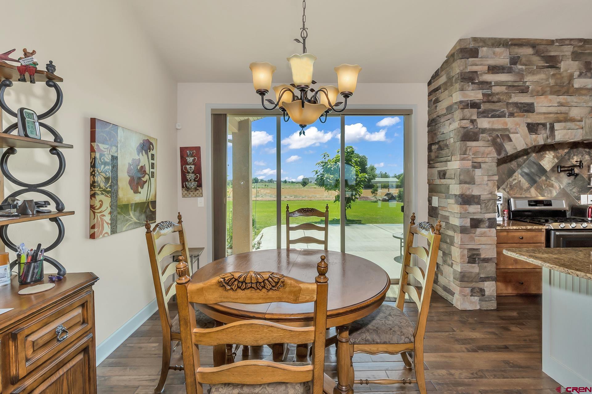 8460 1950th Road Austin, CO 81410 - Photo 6 of 35 a view of a dining room with furniture a chandelier and wooden floor