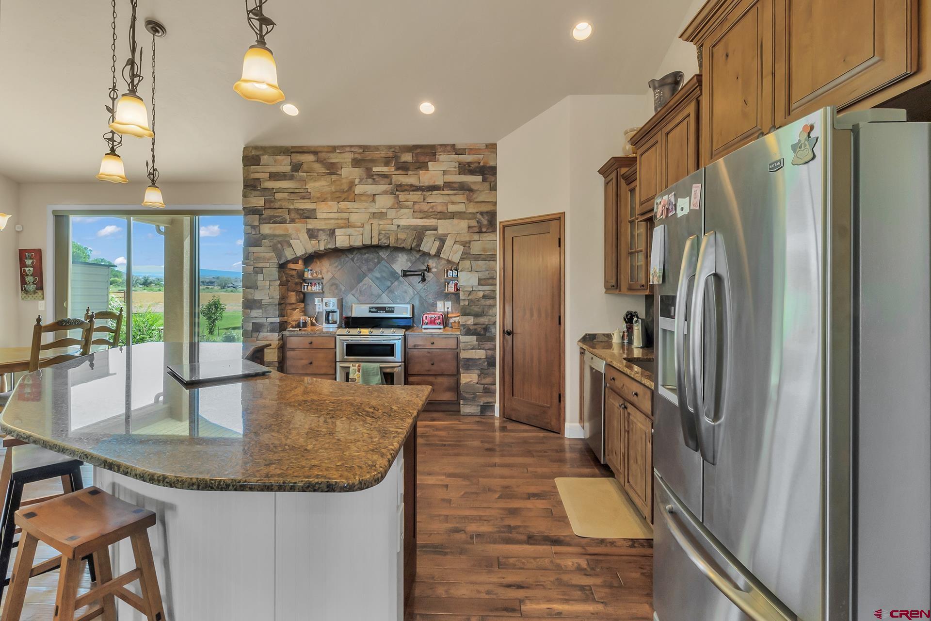 8460 1950th Road Austin, CO 81410 - Photo 7 of 35 a kitchen with stainless steel appliances granite countertop a refrigerator a oven and a sink