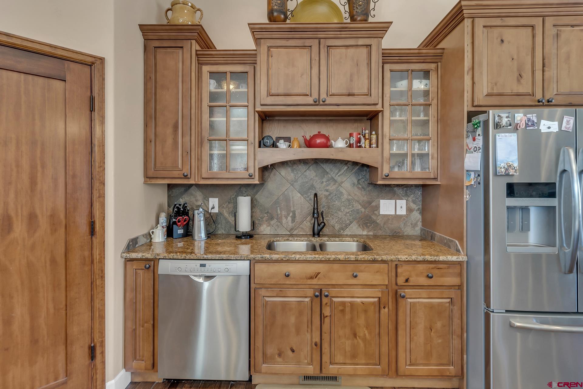 8460 1950th Road Austin, CO 81410 - Photo 8 of 35 a kitchen with stainless steel appliances granite countertop a refrigerator and cabinets