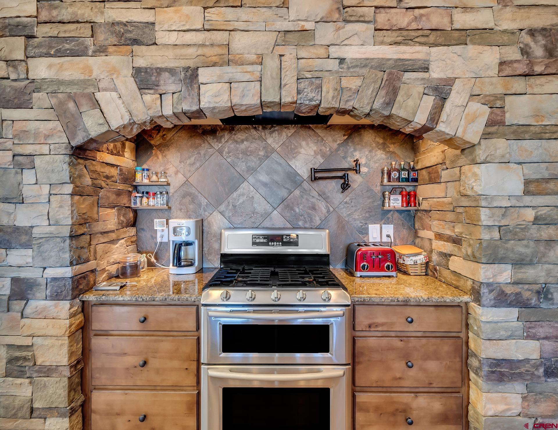 8460 1950th Road Austin, CO 81410 - Photo 9 of 35 a stove top oven sitting inside of a kitchen
