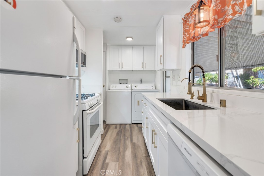 a kitchen with a sink a stove and cabinets