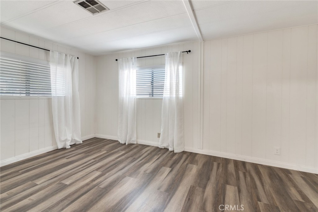 4000 Pierce, Unit 295 Riverside, CA 92505 - Photo 12 of 29 a view of an empty room with wooden floor and a window