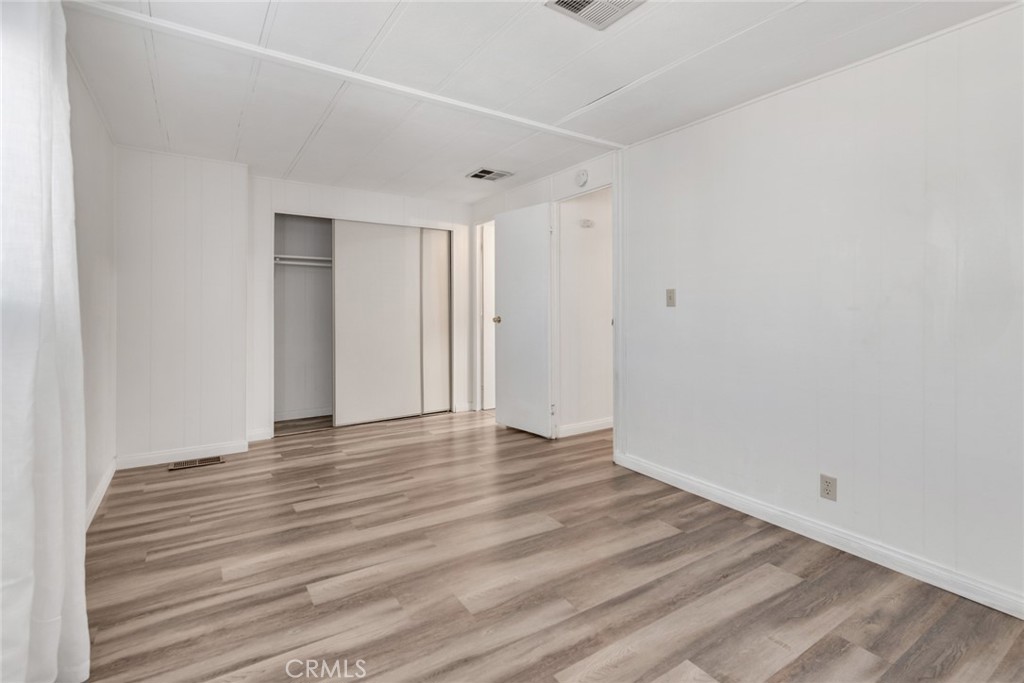 4000 Pierce, Unit 295 Riverside, CA 92505 - Photo 13 of 29 a view of an empty room with wooden floor