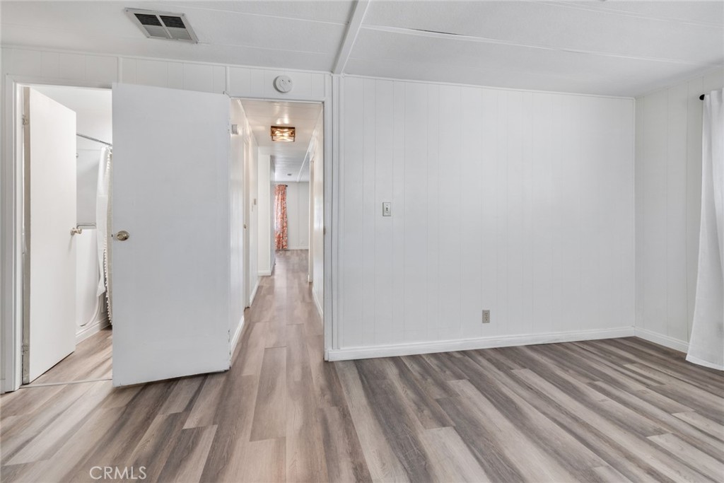 4000 Pierce, Unit 295 Riverside, CA 92505 - Photo 14 of 29 a view of a room with wooden floor and a bathroom