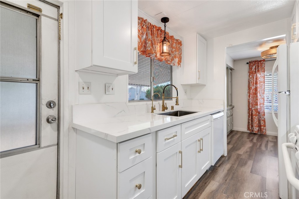4000 Pierce, Unit 295 Riverside, CA 92505 - Photo 2 of 29 a kitchen with white cabinets and a refrigerator