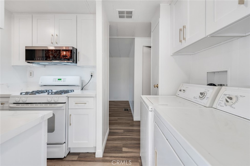 4000 Pierce, Unit 295 Riverside, CA 92505 - Photo 4 of 29 a kitchen with white cabinets and sink