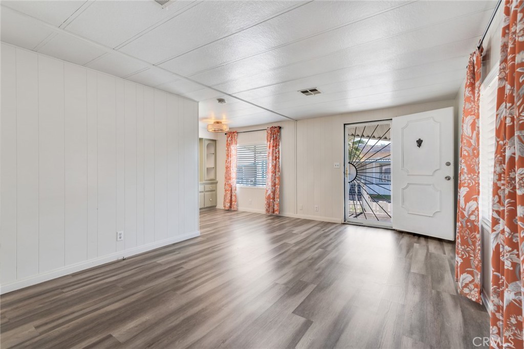 4000 Pierce, Unit 295 Riverside, CA 92505 - Photo 6 of 29 an empty room with wooden floor and windows