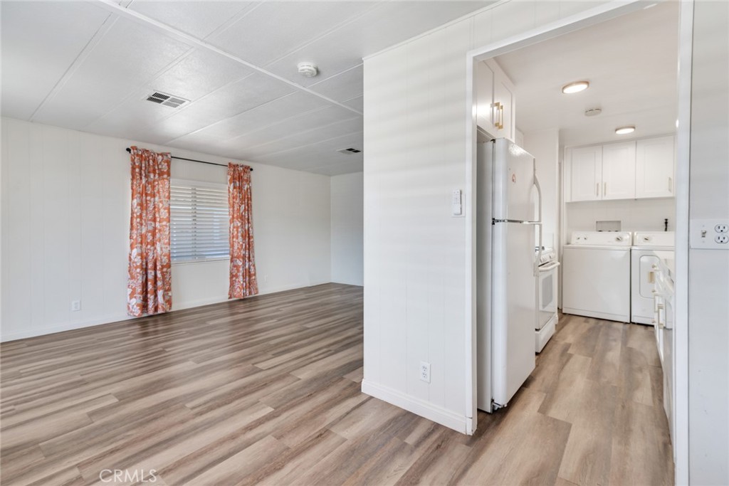 4000 Pierce, Unit 295 Riverside, CA 92505 - Photo 8 of 29 a view of a big room with wooden floor and windows