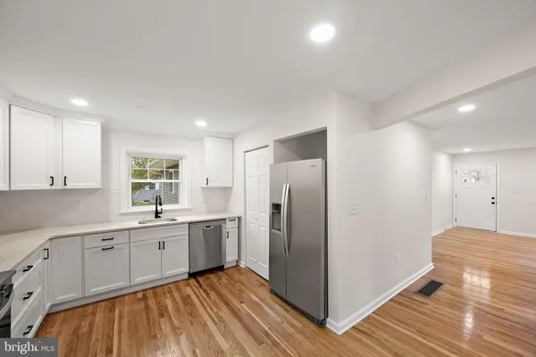 a kitchen with a sink appliances and cabinets