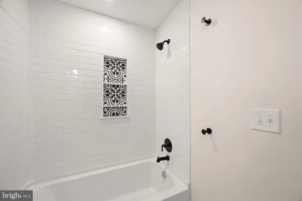 a bathroom with a bathtub and shower